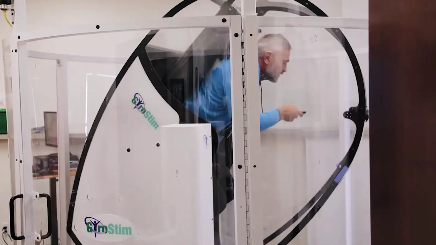 A patient training in the GyroStim multi-axis rotational chair