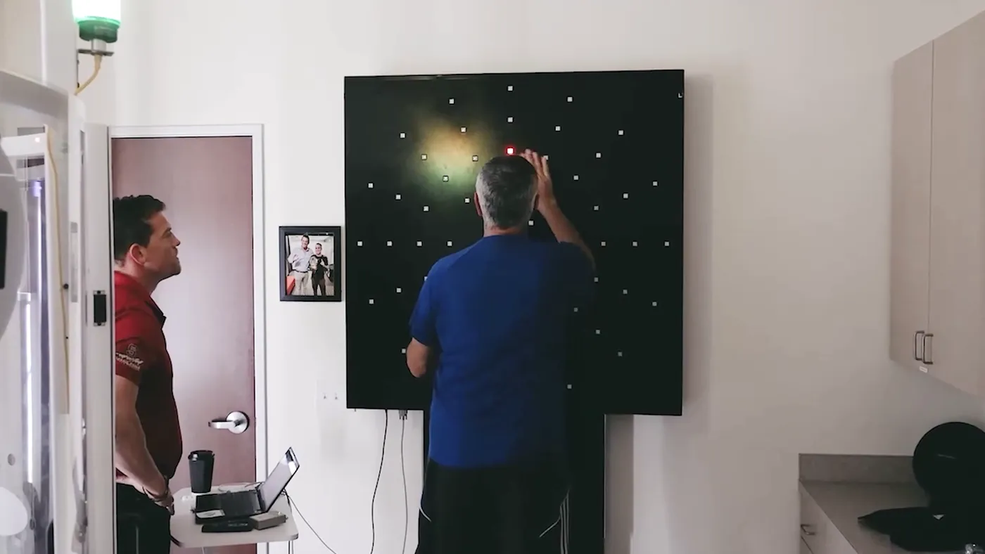 A patient working the DynaVision light board