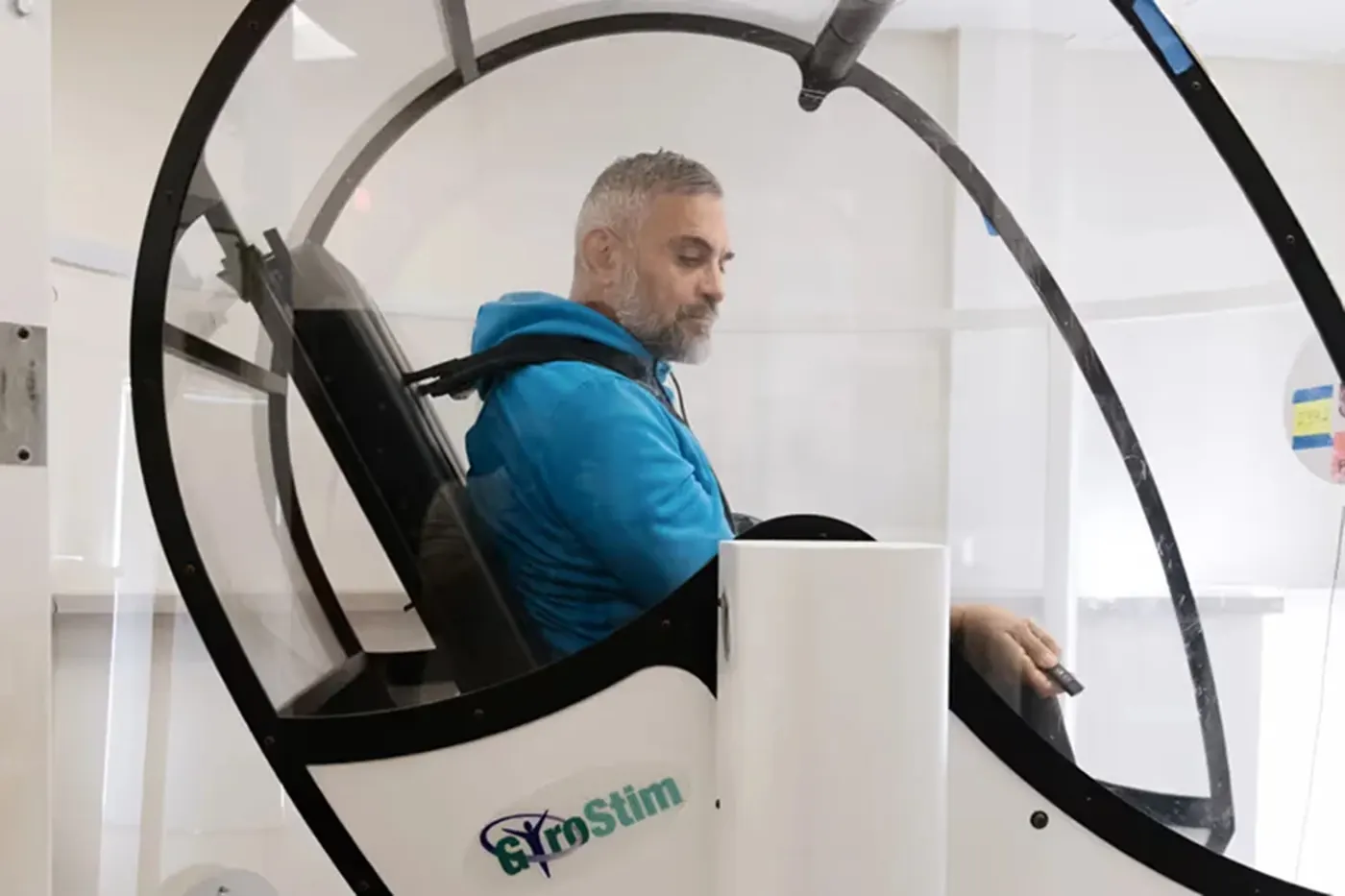 A patient seated in the GyroStim